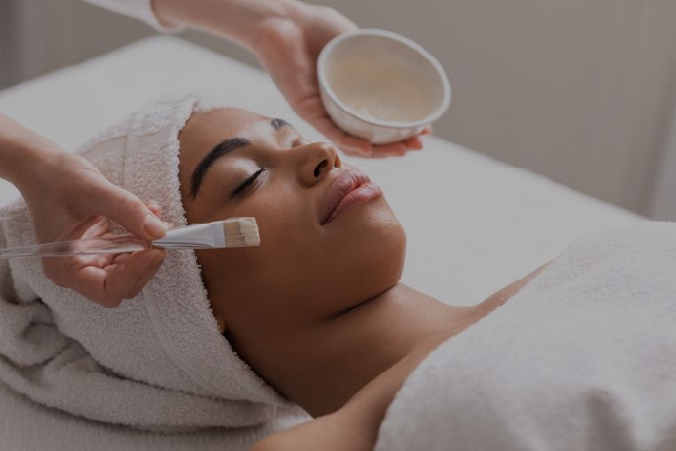 Spa professional applying a chemical peel to a client’s face