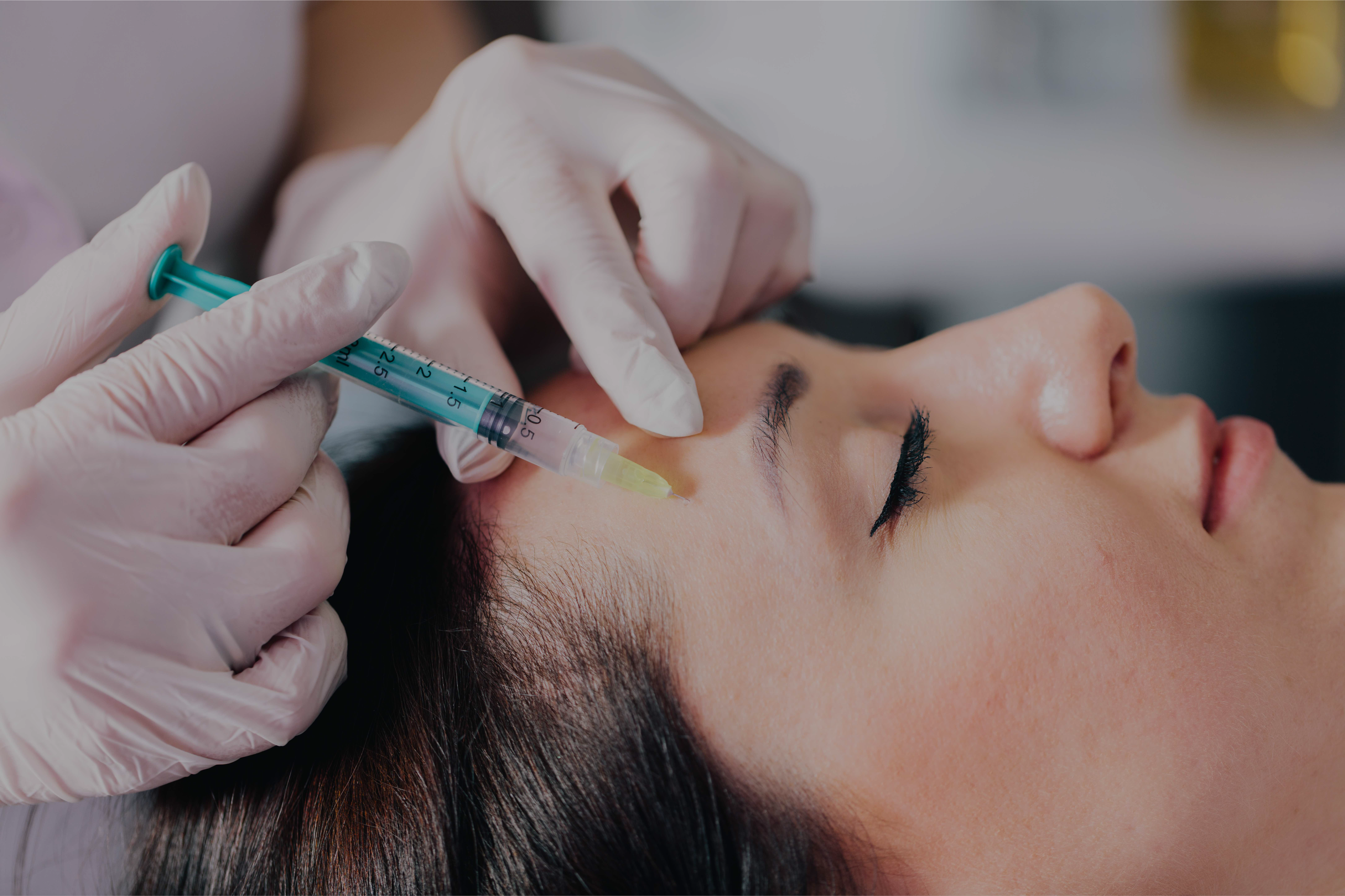 Woman receiving a high-tech facial treatment in a medical spa